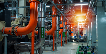 A mechanical equipment room with chillers serving a commercial facility. 