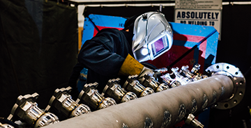CCI’s certified welders works on a piece of fabricated pipe. 